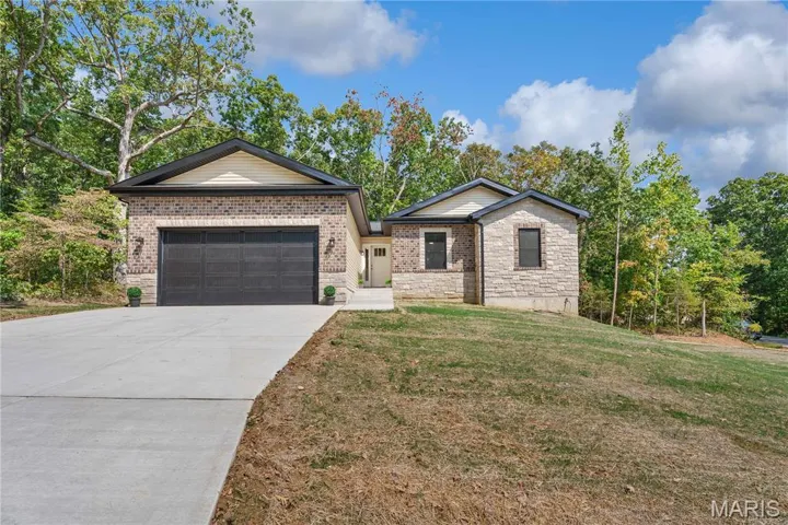 This PREMIUM NEW CONSTRUCTION home in the popular, gated Raintree Plantation lake/golf community has beautiful curb appeal with stone and brick front.