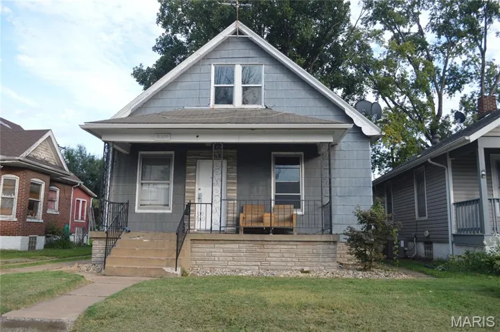 View of front of home featuring covered porch and a front yard