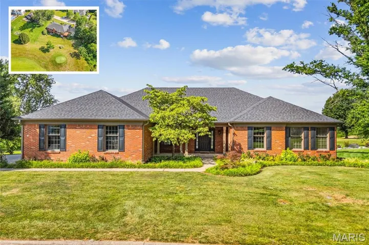 View of front facade featuring brick siding, a front yard, and a shingled roof