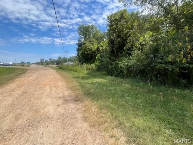 View of dirt / gravel road with a rural view