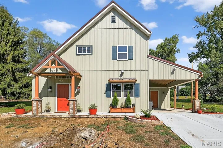 View of front of property with a carport, board and batten siding, and concrete driveway