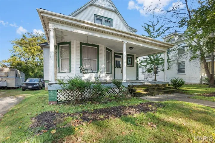 View of front of house with a front lawn and a porch