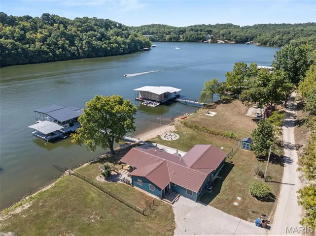 Bird's eye view of a nearby body of water and a heavily wooded area