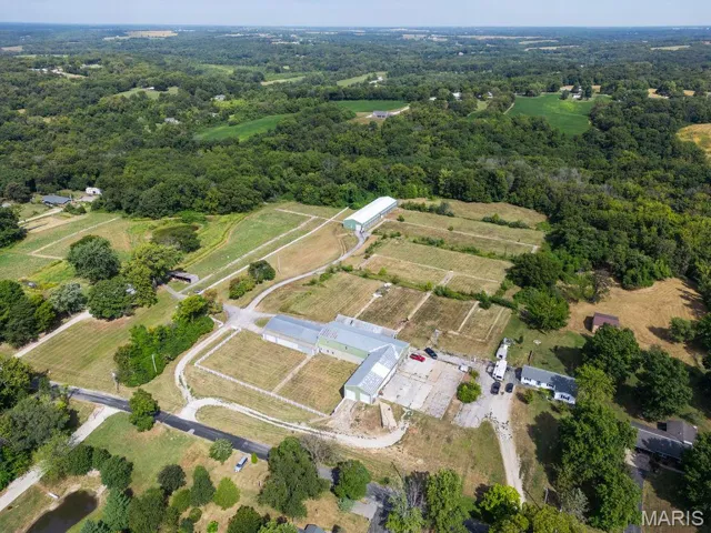 Aerial view of property's location with rural landscape and abundant farmland