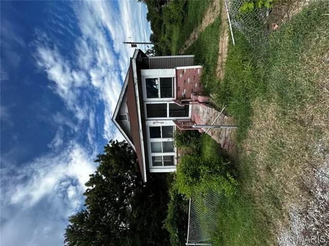 Bungalow-style house with brick siding