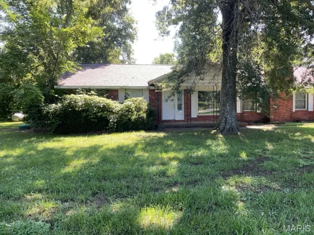 Ranch-style home with brick siding and a front lawn