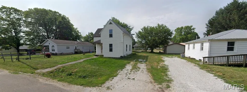 View of front of house featuring a front lawn and driveway