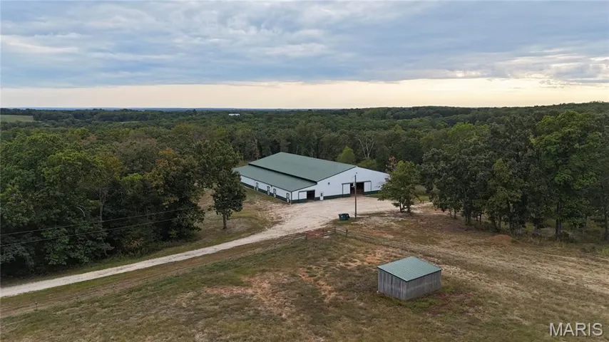 View from above of property featuring a heavily wooded area