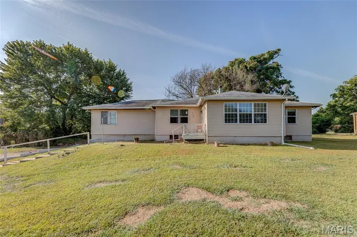 Ranch-style house with a front yard and crawl space
