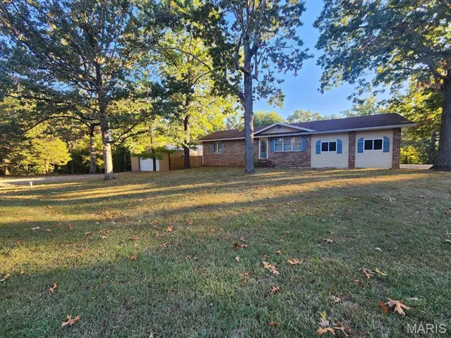 View of front facade featuring brick siding and a front lawn