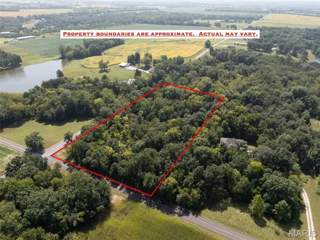 Aerial view of sparsely populated area featuring property parcel outlined