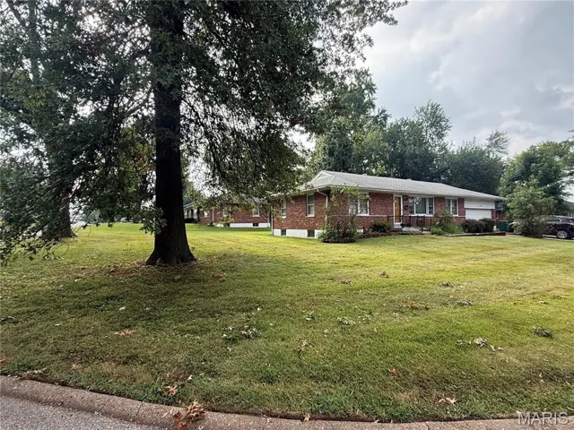 Single story home featuring a front lawn and brick siding
