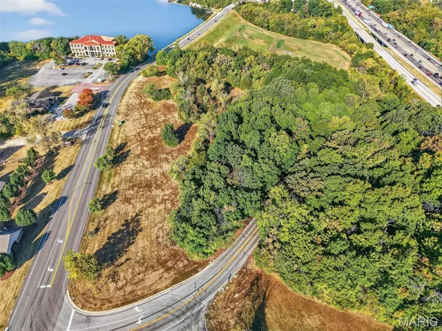Aerial overview of property's location with a major roadway and a large body of water
