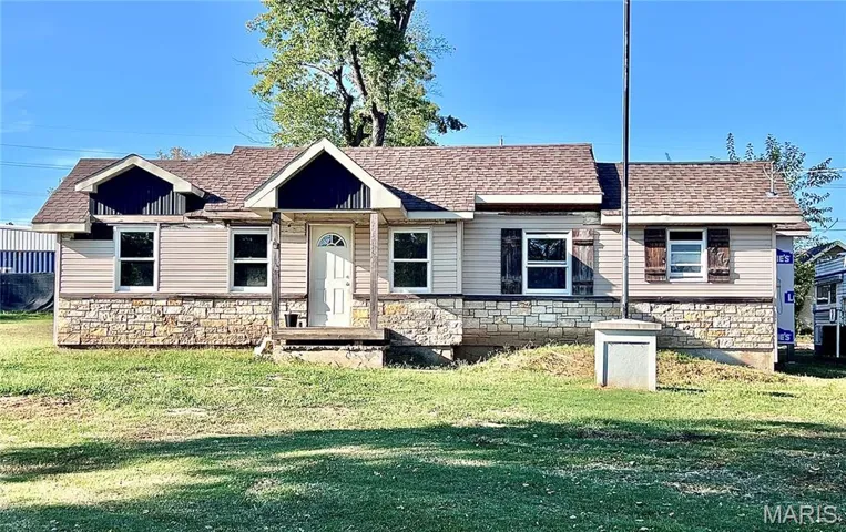 View of front of home featuring stone siding and entry way.