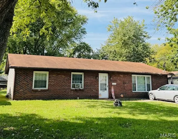 Ranch-style house with a front lawn and brick siding