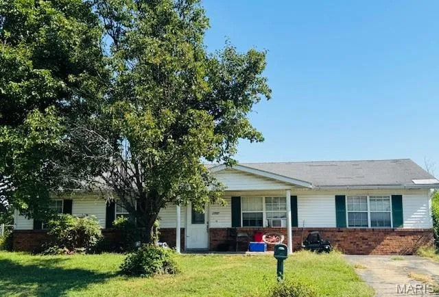 Ranch-style house with brick siding and a front lawn