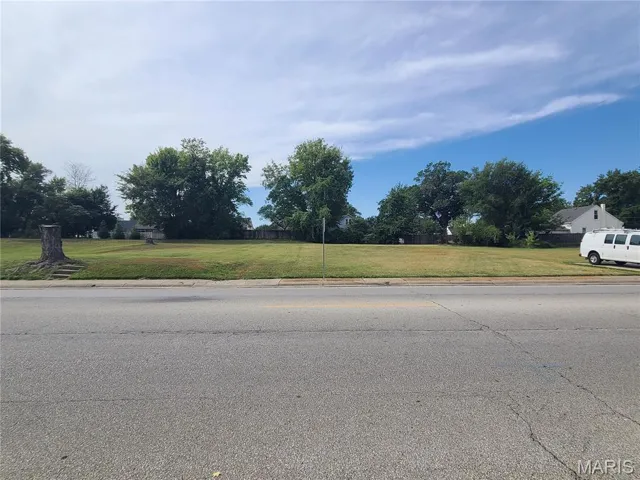 View of asphalt road featuring curbs