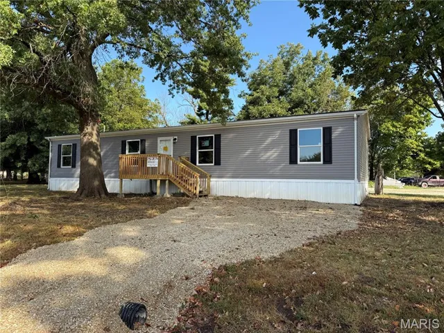 Manufactured / mobile home with a wooden deck