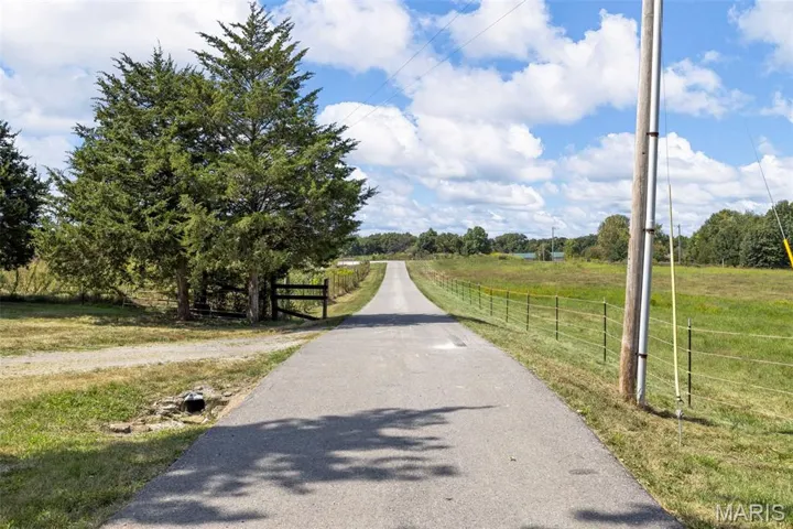 View of asphalt street featuring a view of rural / pastoral area
