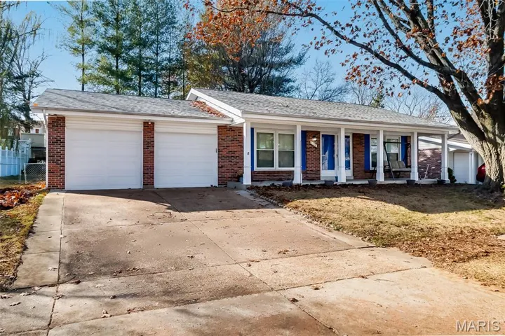 Single story home with a shingled roof, concrete driveway, brick siding, and an attached garage