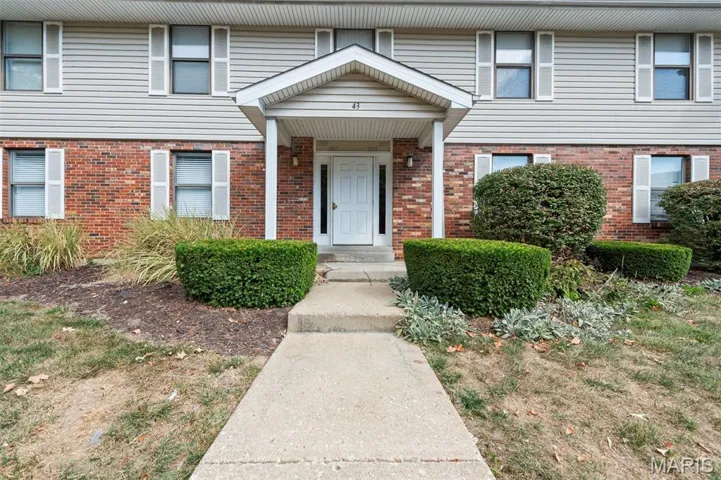 Doorway to property with brick siding
