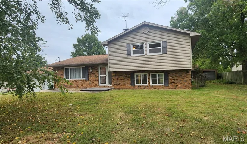 Split level home with brick siding
