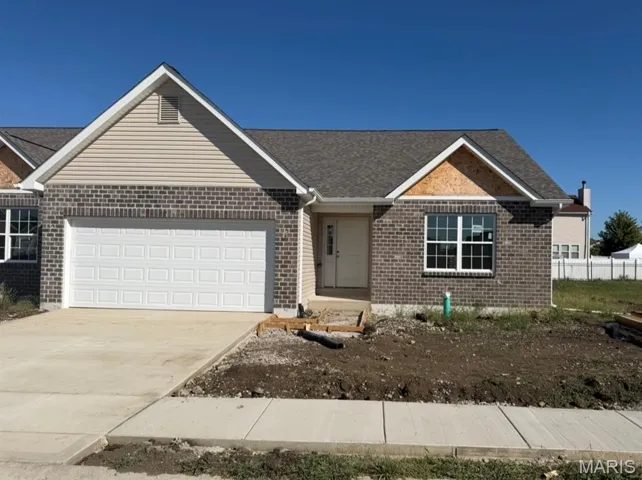 Ranch-style house featuring brick siding, an attached garage, concrete driveway, and roof with shingles