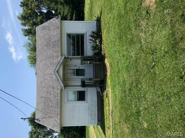 Bungalow-style house featuring a front yard and a shingled roof