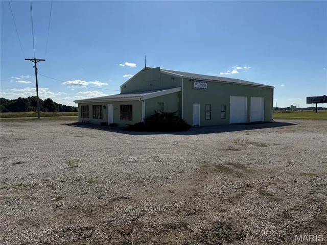 Rear view of house with a detached garage