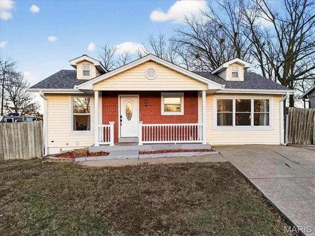 Ranch home with a porch and roof with architectural shingles