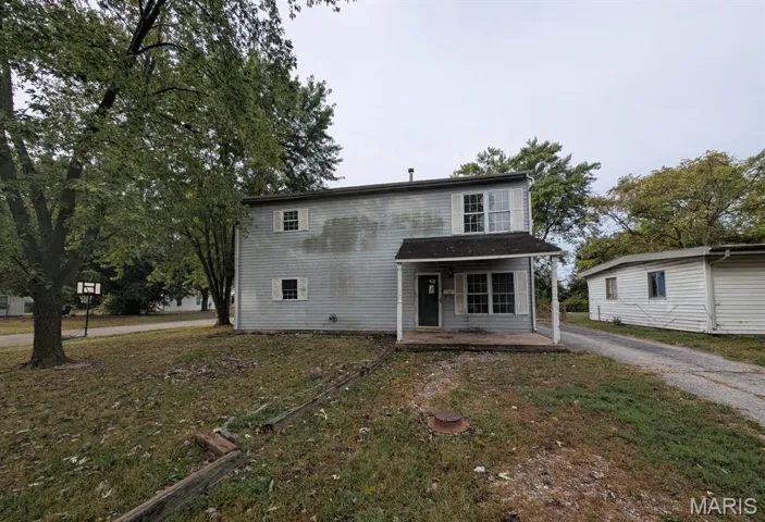 Traditional home featuring a front yard