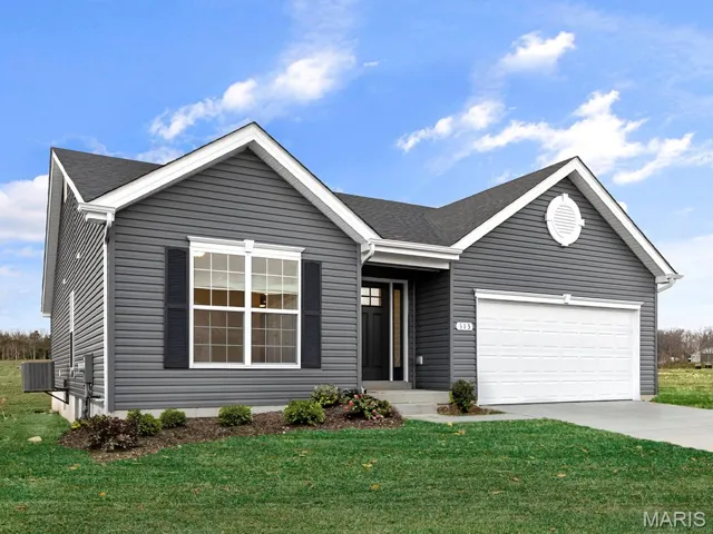 Ranch-style home with a front yard, driveway, and a garage