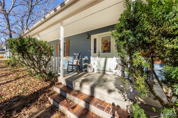 View of exterior entry with a porch