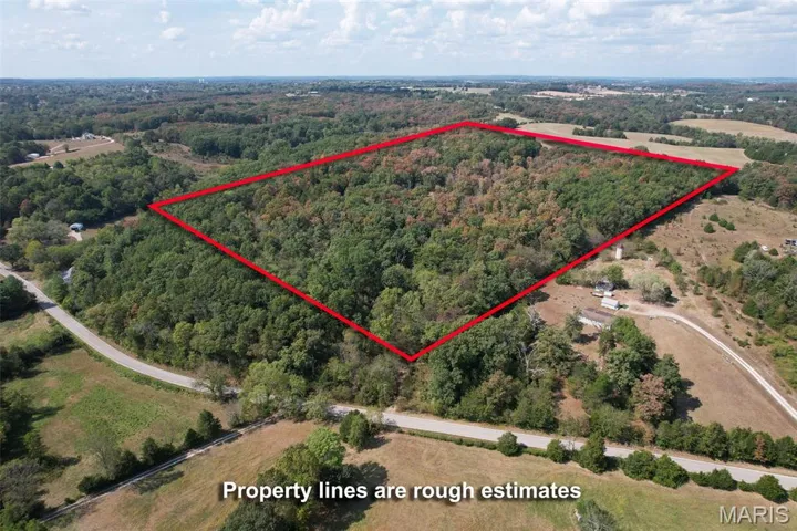 Aerial view of property and surrounding area with property parcel outlined