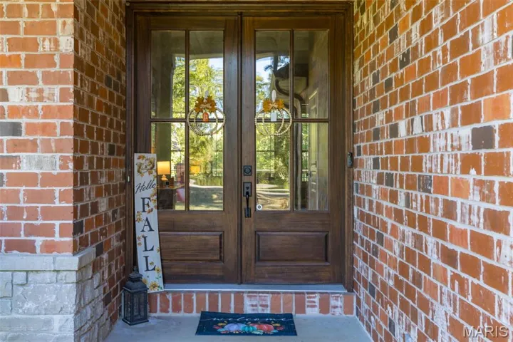 Doorway to property with french doors and brick siding