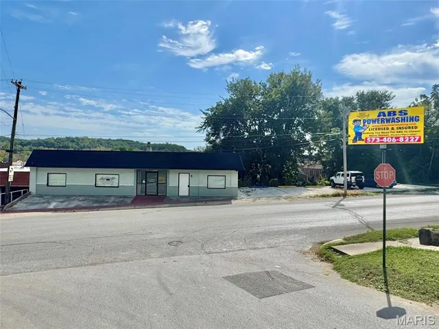 View of asphalt road featuring traffic signs