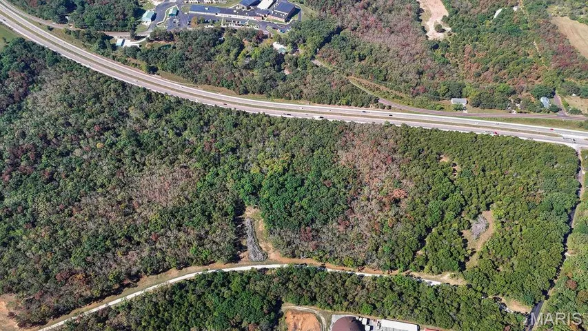 Aerial overview of property's location featuring a forest