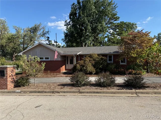 Ranch-style house with brick siding