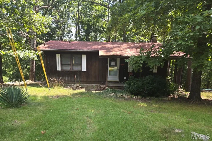View of front of home with a front yard and a chimney