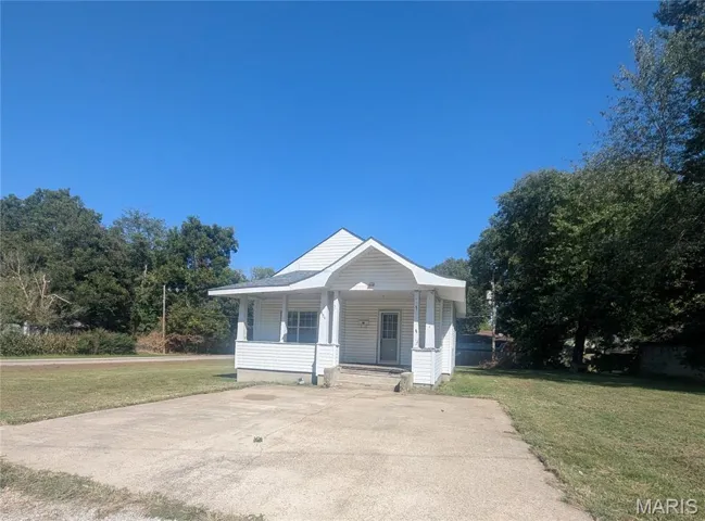 Bungalow-style home featuring a front lawn and covered porch