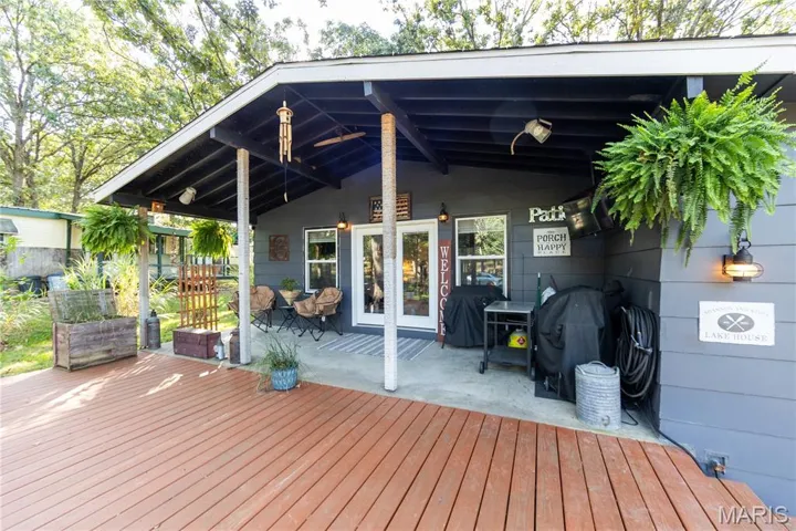 Wooden deck with a patio and area for grilling