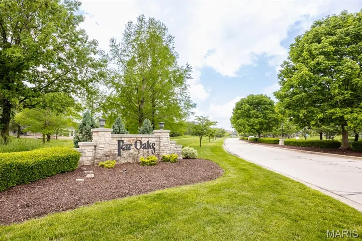 Community / neighborhood sign with a yard