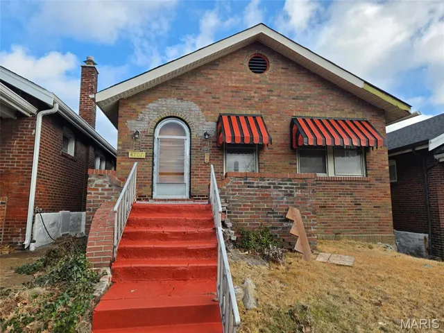 View of front of property with brick siding