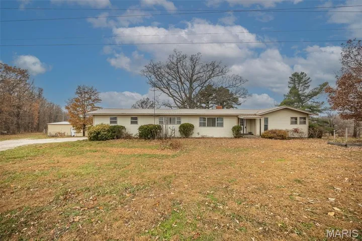 Ranch-style house with a front lawn