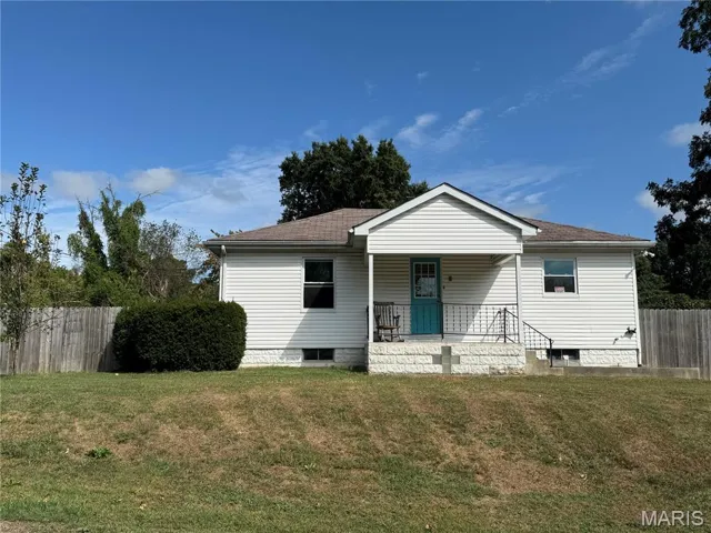 View of front facade featuring covered porch and roof with shingles