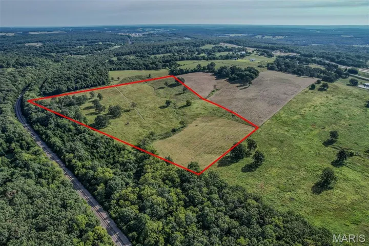 View of rural area featuring a heavily wooded area and property boundaries highlighted