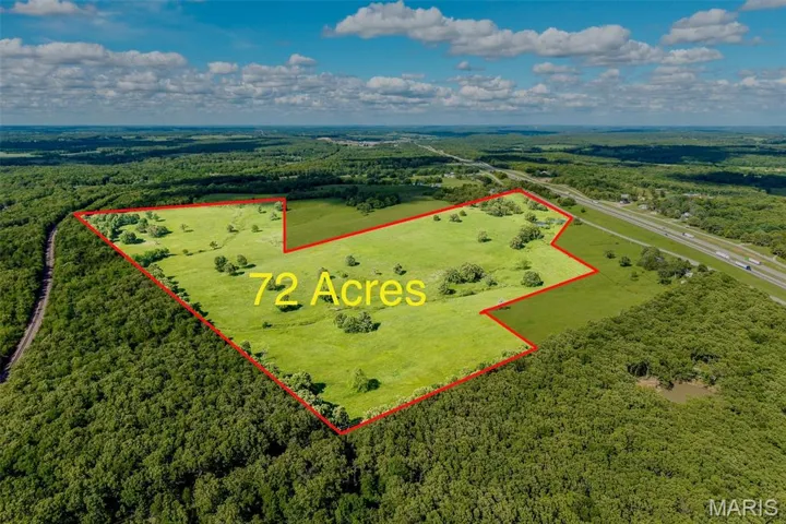 Aerial overview of property's location with a forest and property parcel outlined