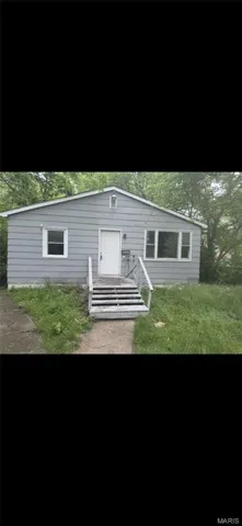 Back of house with a yard