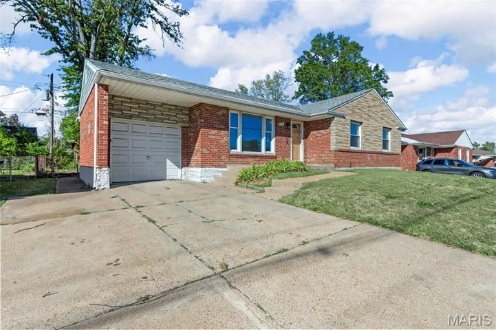 Ranch-style house with concrete driveway, brick siding, roof with shingles, a front yard, and a garage