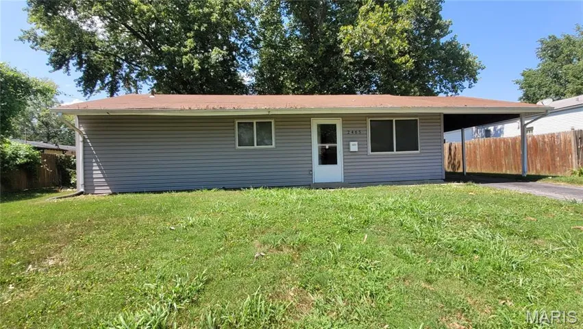 View of front of home with driveway and an attached carport